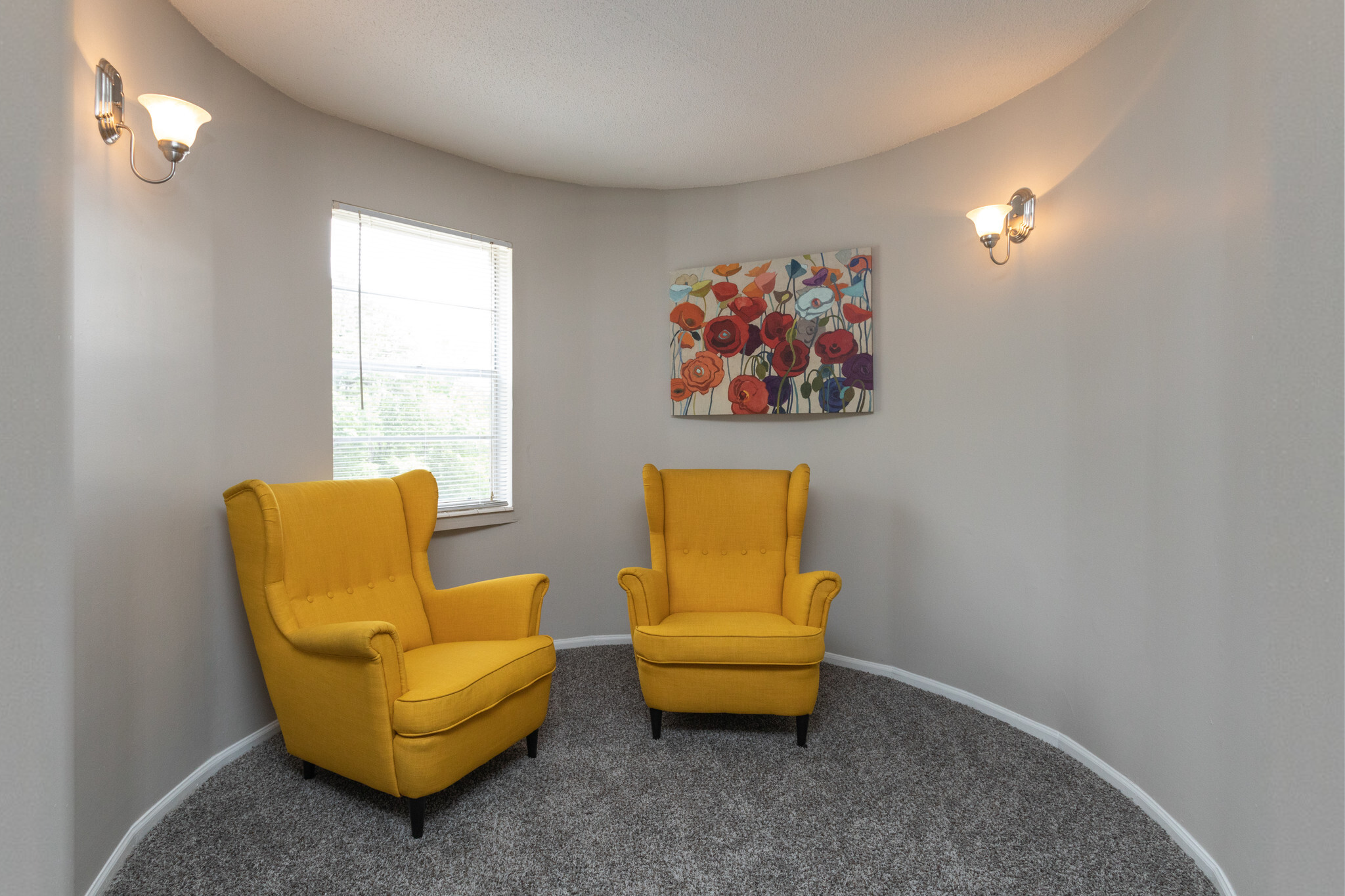 Westside Commons interior apartment. Living room with sofa, chairs and beautiful canvas paintings